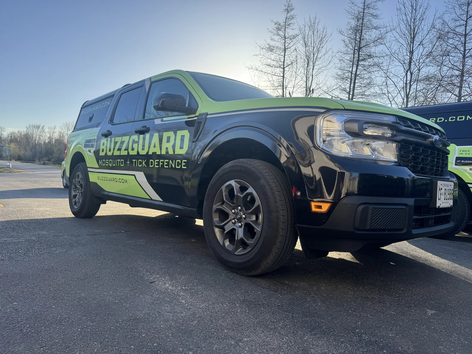 A wrapped BuzzGuard service truck on site