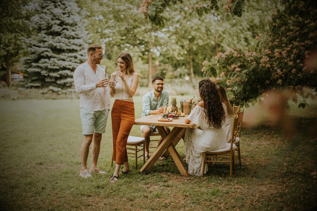 group of happy young people smiling together outdoors
